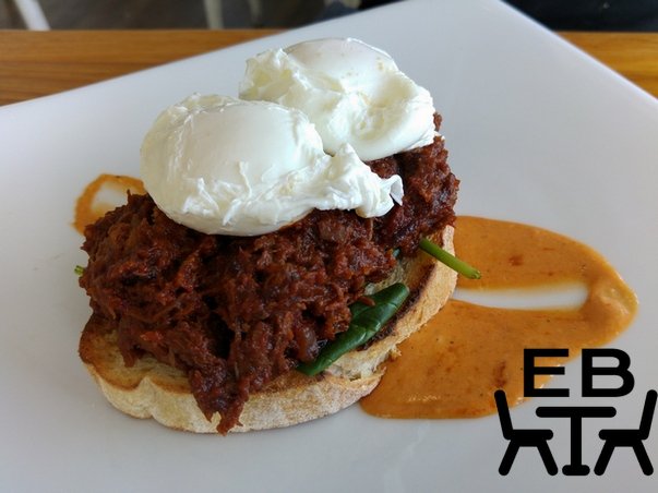 Slow braised beef in tomato and herbs with poached eggs, chipotle sauce, and spinach, on sourdough.